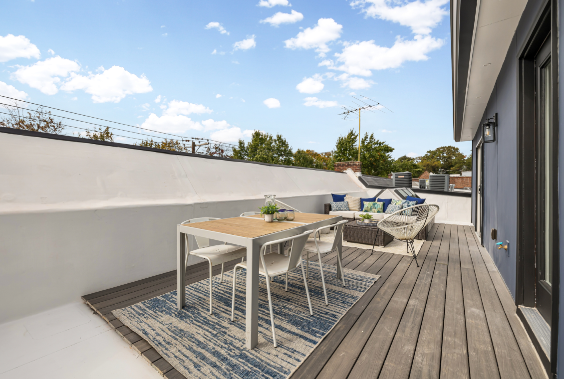 Rooftop patio with dining table and chairs
